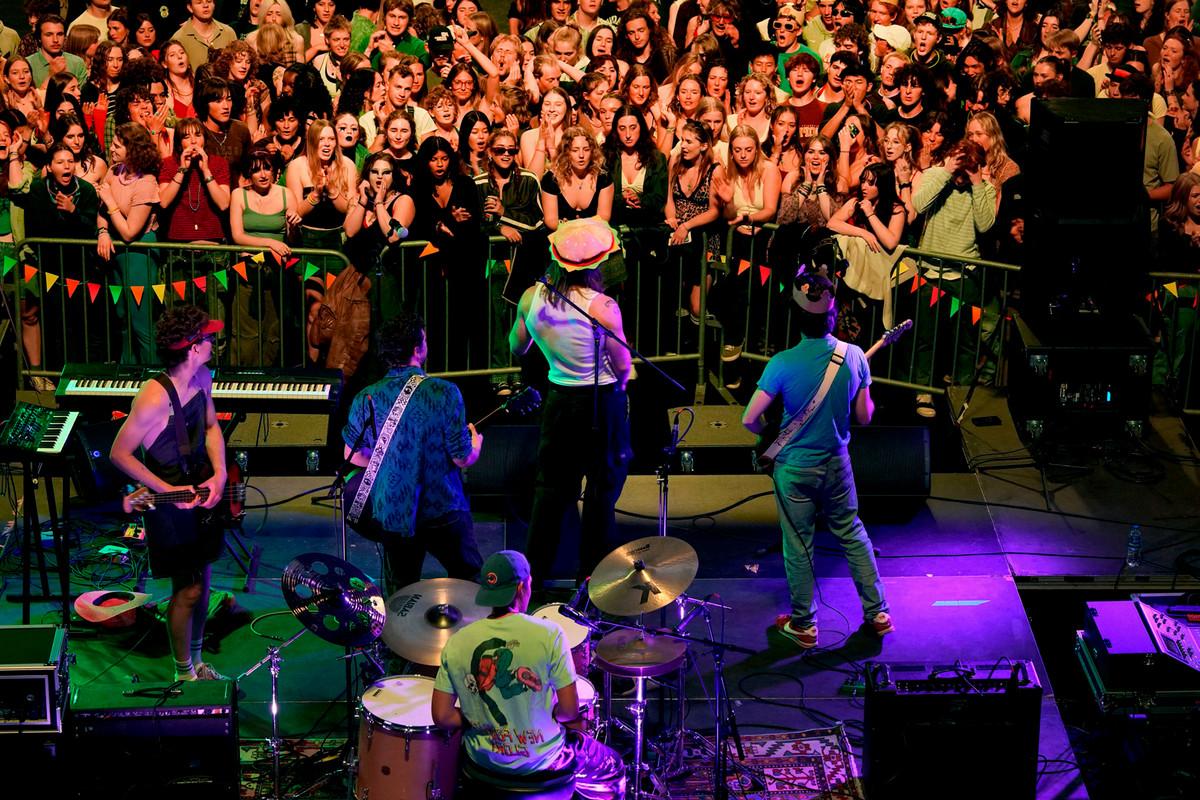 Students and audience members sing and cheer during Burgertown’s performance for the second round of Battle of the Bands on March 30 at Robson Arena. Photo by Jamie Cotten